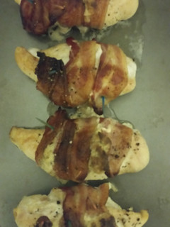 A picture of Bacon wrapped, stuffed chicken breast..