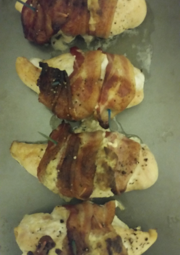 A picture of Bacon wrapped, stuffed chicken breast..