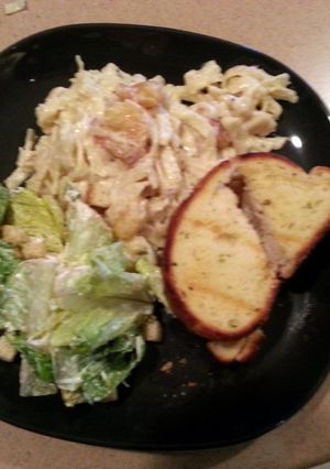 A picture of shrimp pasta with garlic and herbs.