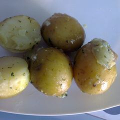 A picture of Baby new potatoes in herb butter.