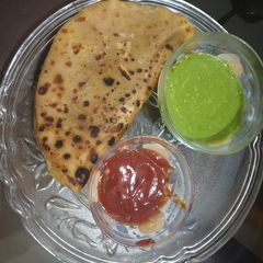 A picture of Aloo cheese parantha with tangi Dip.