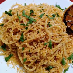 A picture of Spaghetti with anchovy butter, crispy crumb and seared lemon.