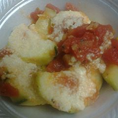 A picture of Zucchini and tomato parmesan.