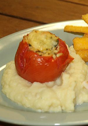 A picture of MOROCCAN STUFFED TOMATOES with CREAMY POTATO PUREE.