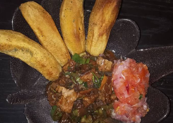 Fried plantains,with beef stew and a side of kachumbari(salsa)