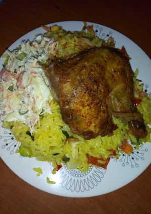 A picture of Fried rice,chicken and salad.
