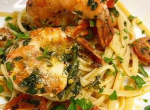 A picture of Spanish garlic tiger prawns with linguine.
