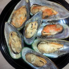 A picture of Mussel parmesan.