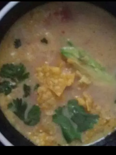 A picture of Cheesy amazing tortilla soup.