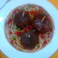 A picture of Cheese meatballs in tomato sauce.