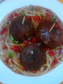 A picture of Cheese meatballs in tomato sauce.