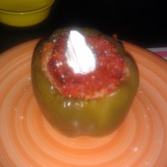 A picture of sausage stuffed bell pepper.