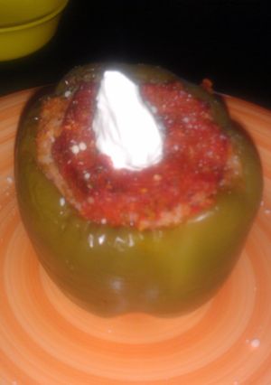 A picture of sausage stuffed bell pepper.