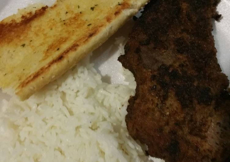 Fried steak with rice and garlic bread