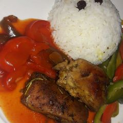 A picture of Grilled chicken with raisin rice.