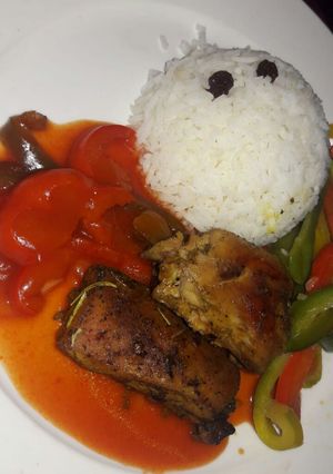 A picture of Grilled chicken with raisin rice.