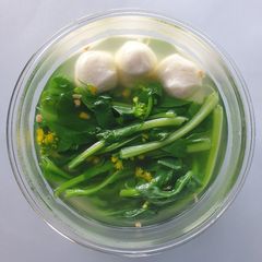 A picture of Choy sum with fish ball soup.