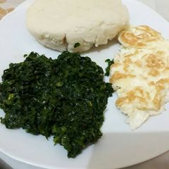 A picture of Sautéed Kale +fried Omelette with Ugali.