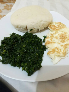 A picture of Sautéed Kale +fried Omelette with Ugali.