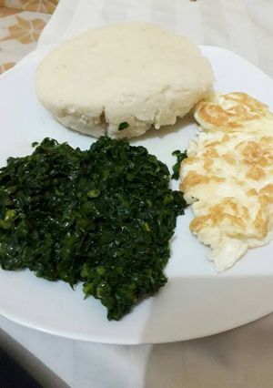 A picture of Sautéed Kale +fried Omelette with Ugali.