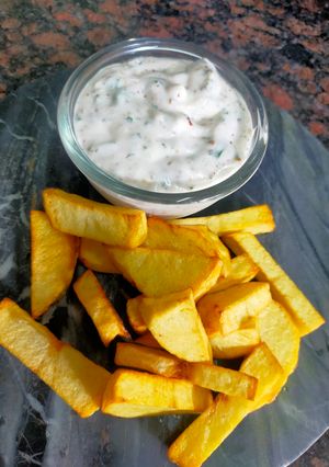 A picture of Ranch Dressing with Potato Wedges.