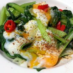 A picture of Bak Choy With Soft Boiled Eggs.