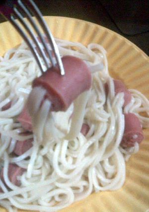 A picture of sausage with noodles.