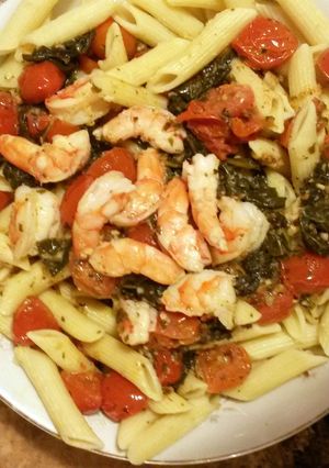 A picture of shrimp tomato spinach ziti.