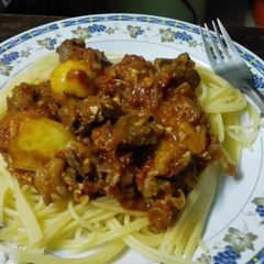 A picture of Spaghetti Beef stew with grilled potatoes.