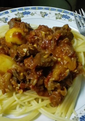 A picture of Spaghetti Beef stew with grilled potatoes.