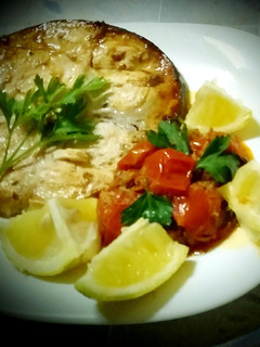 A picture of Grilled swordfish and cherry tomato sauce, swordfish, capers.