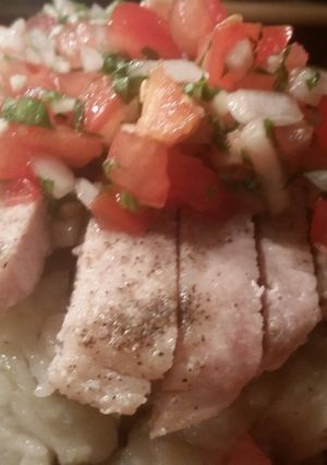 A picture of Tomato Basil Insalata over Sliced Broiled Pork Loin and Mashed Potatoes..