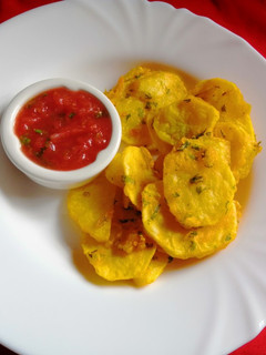 A picture of Potatoes bhajia with tomato-mango salsa dip.