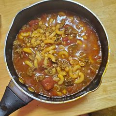 A picture of Tomato pasta soup with beef.