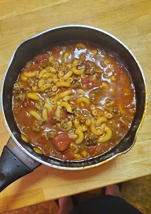 A picture of Tomato pasta soup with beef.