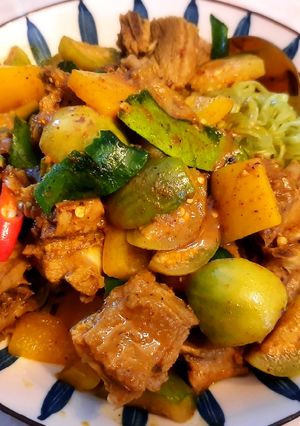 A picture of Red Curry with Braised Duck over Vegetable Noodles.