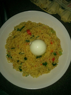A picture of Vegetable Indomie and boiled egg.