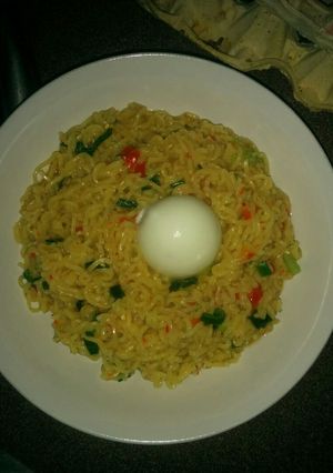 A picture of Vegetable Indomie and boiled egg.