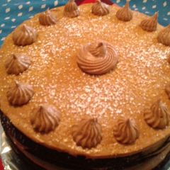 A picture of Chocolate cake with chocolate cream cheese frosting and toffee.