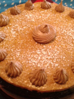 A picture of Chocolate cake with chocolate cream cheese frosting and toffee.