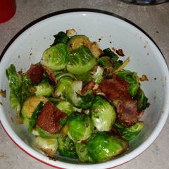 A picture of Brussel sprouts with bacon and onion.
