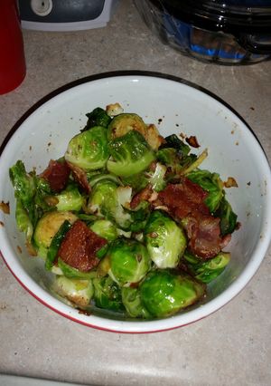 A picture of Brussel sprouts with bacon and onion.