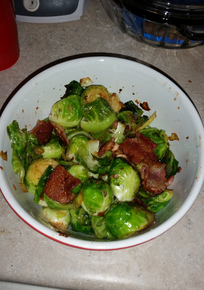 A picture of Brussel sprouts with bacon and onion.