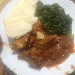 A picture of Ugali served with fried beef and spinach.