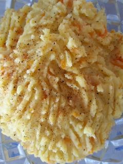 A picture of Mash potatoes carrots with bacon.
