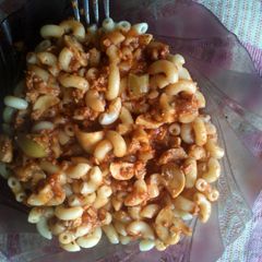 A picture of macaroni with bolognese sauce.