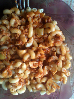 A picture of macaroni with bolognese sauce.