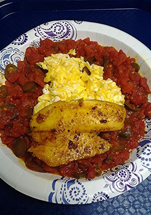 A picture of Spicy tomatoes with eggs and tilapia.