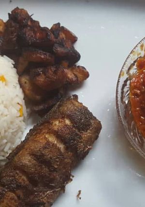 A picture of Rice with turkey and tomato sauce.