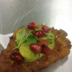 A picture of Tapas -- Plantain with a pomegranate guacamole.